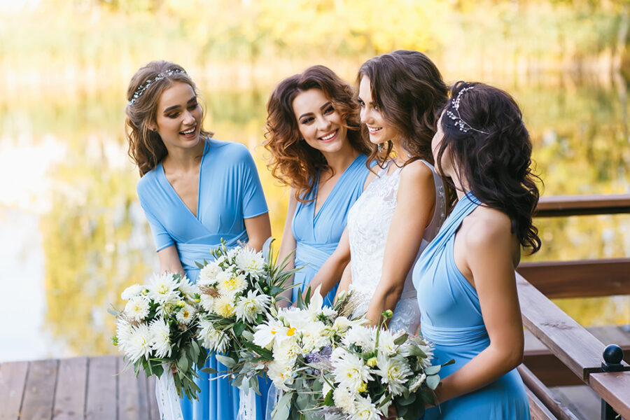 Bride with bridesmaids on the park on the wedding day