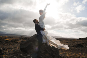 Ecstatic bride held by young man