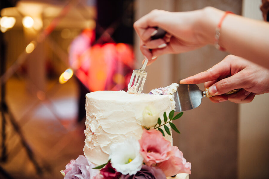 Beautiful delicious white wedding cake ceremony at the table