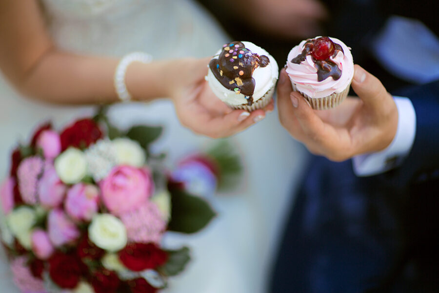 couple holding cakes top view
