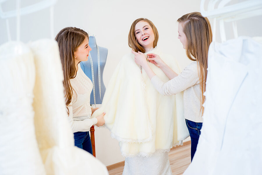 Bride with her bridesmaids are at the wedding shop